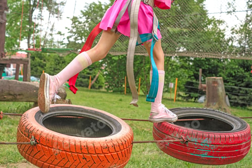 Preview: A child runs an obstacle course on suspended tire wheels