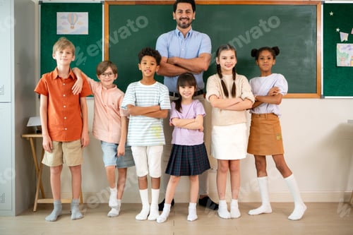 Preview: Confident diverse students and teacher posing together in an international classroom