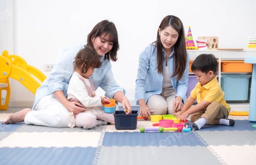 Preview: Teachers and parent playing joyfully with children