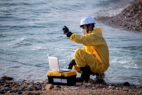 Preview: Scientists in yellow suits are collecting water samples from the coastline