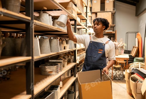 Preview: Warehouse worker picking products and placing them into a box