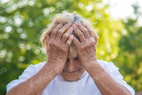 Preview: The old woman grandmother has a headache. Selective focus.
