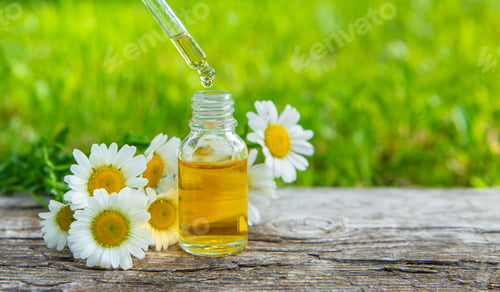 Preview: Chamomile essential oil and supplements. Selective focus.