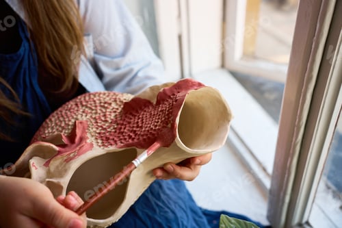 Preview: Ceramic finishing process coating textured clay with decorative glaze.