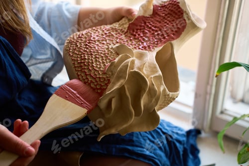 Preview: Detailed shot of paintbrush bristles moving glaze over varied ceramic textures.