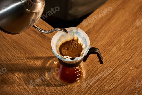 Preview: Specialty coffee brewing. Barista pours hot water into a light blue ceramic dripper.