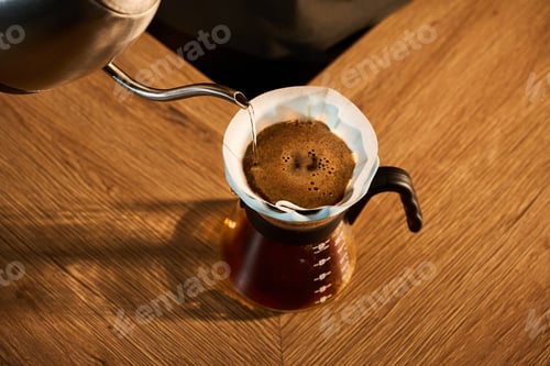 Preview: Specialty pour-over coffee brewing in a light blue ceramic dripper with metal kettle.