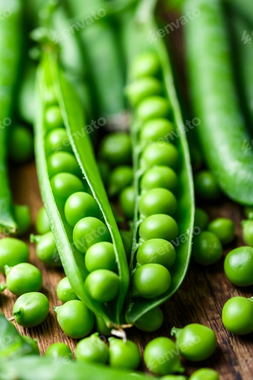 Preview: Fresh green peas in pods forming natural food background