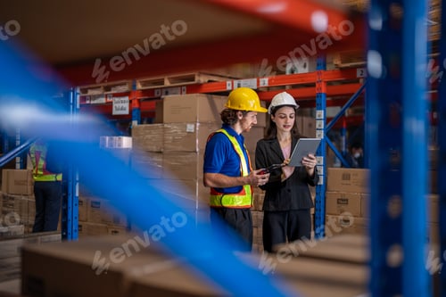 Preview: Logistics team of engineers and a manager discuss inventory with a tablet inside a large distributio