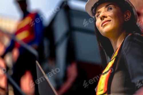 Preview: Two logistics workers man and woman discuss operations at a busy shipping container yard. successful