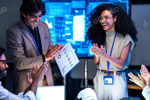 Preview: Diverse technology team including South Asian, Black, and white professionals reviews AI project res