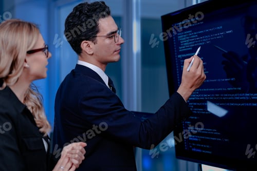 Preview: Code breakthrough achieved. Smiling senior developer points to a successful code segment on screen,