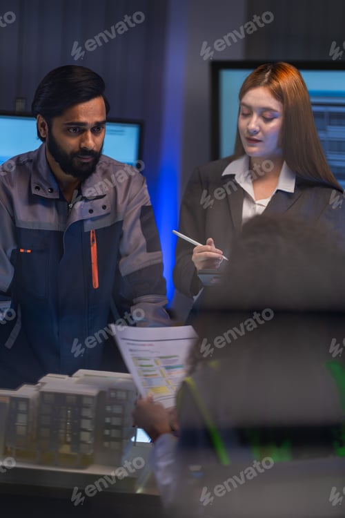 Preview: Construction team with South Asian male engineer and female architect review architectural documents