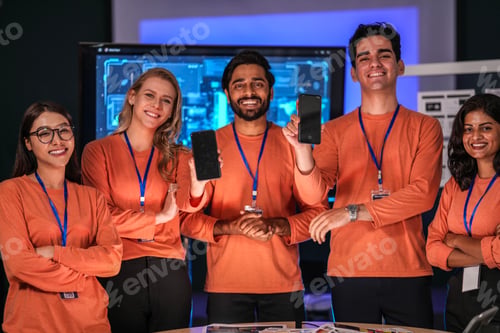 Preview: A successful, diverse team of young professionals in a modern tech company proudly presents their ne