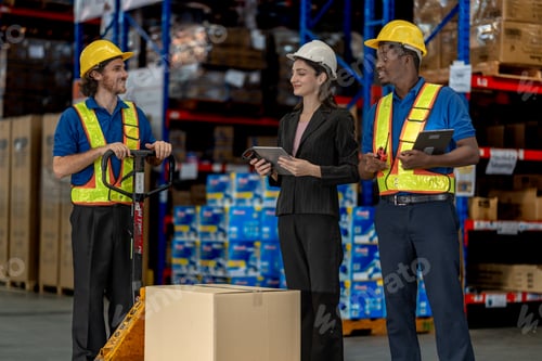 Preview: A diverse logistics team utilizing digital tablets, a walkie-talkie, and a hand pallet jack to verif