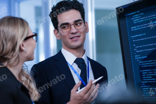Preview: Deep code analysis huddle late night. Senior developer points out intricate logic colleague absorbs