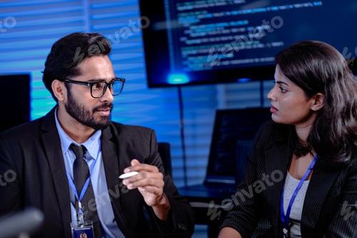 Vista previa: Sesión de estrategia enfocada a altas horas de la noche. Un gerente masculino con gafas hace gestos explicando puntos complejos a