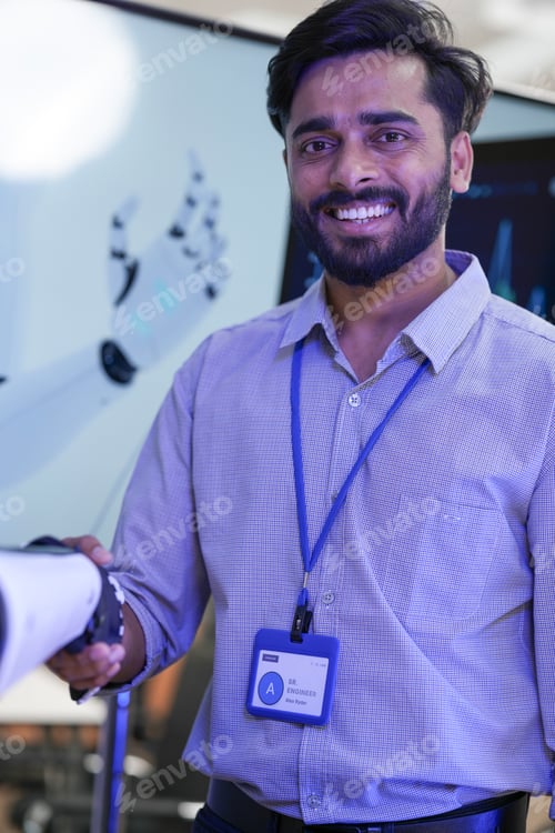Preview: Portrait of a smiling senior robotics engineer finalizing a machine learning handshake test with an