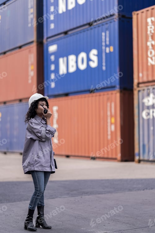 Preview: Asian Woman Logistics Workers Walking to Check Container. Operations at a Busy Shipping Container Ya