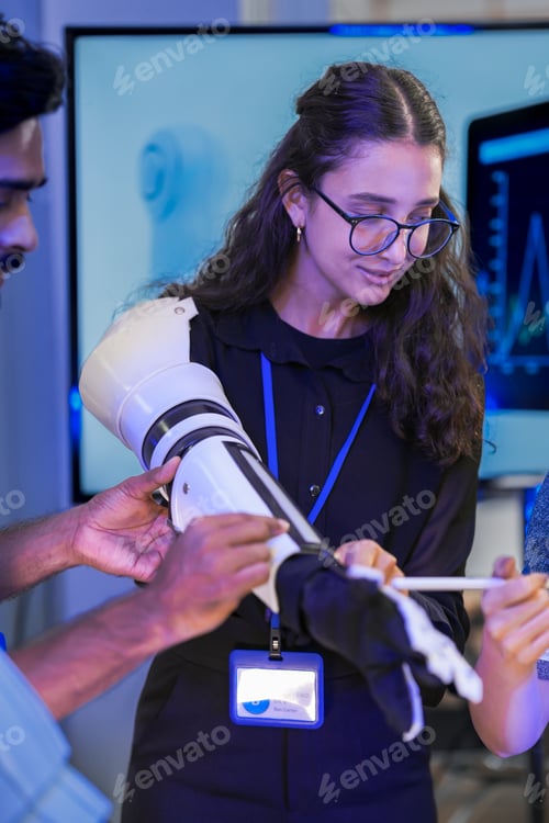 Preview: A female robotics engineer adjusting micro-servo mechanics on a bionic prosthetic arm prototype link