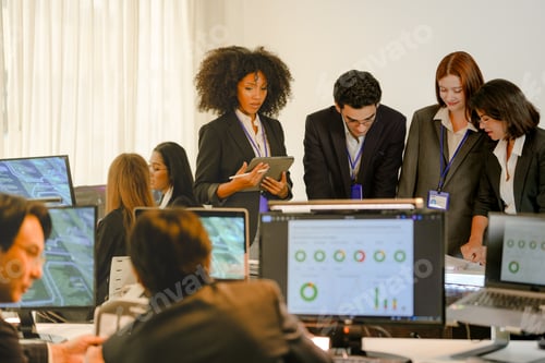Preview: Focused cybersecurity squad reviewing predictive analytics on documents. Professional multiethnic de