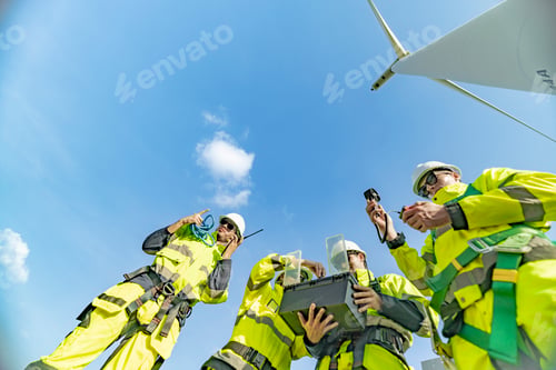Preview: A team of engineers celebrates success after completing wind turbine maintenance at a wind farm. Ren