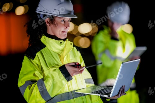 Preview: Professional industrial engineer in safety uniform collecting a fuel sample for quality inspection a