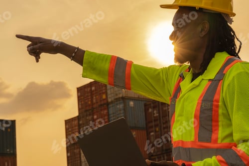 Preview: African logistics workers man cheking on site area operations at a busy shipping container yard at s
