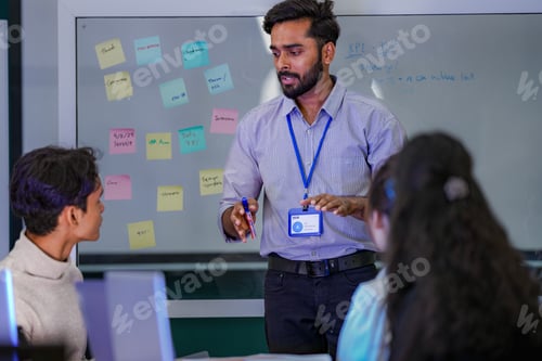 Preview: A senior technology consultant leaning over a desk to point out system optimization parameters and a