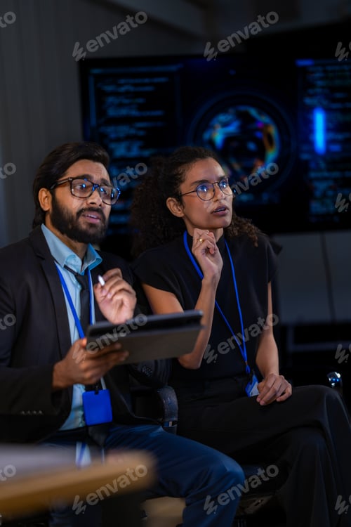 Preview: South Asian male cybersecurity professional and Black female IT engineer with a robotic arm review d