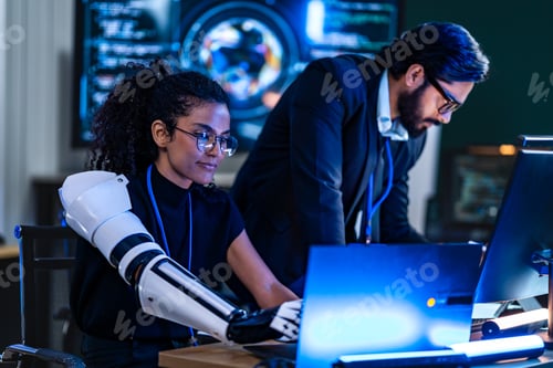 Preview: South Asian male and Black female cybersecurity analysts review an incident response plan together i