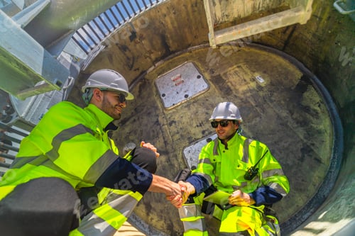 Preview: Professional wind turbine technicians in safety gear performing a detailed technical inspection insi