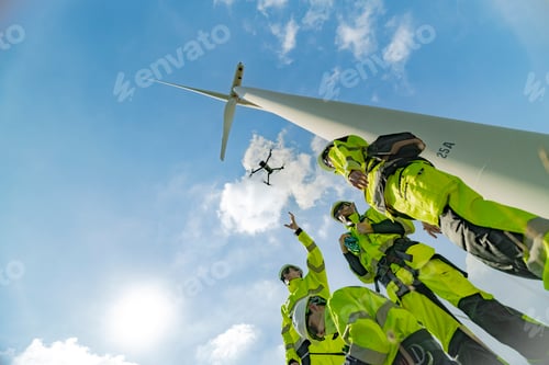 Preview: Engineers use a drone to inspect a wind turbine on a bright day, showcasing the integration of techn