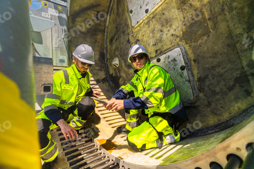 Preview: Professional wind turbine technicians in safety gear performing a detailed technical inspection insi