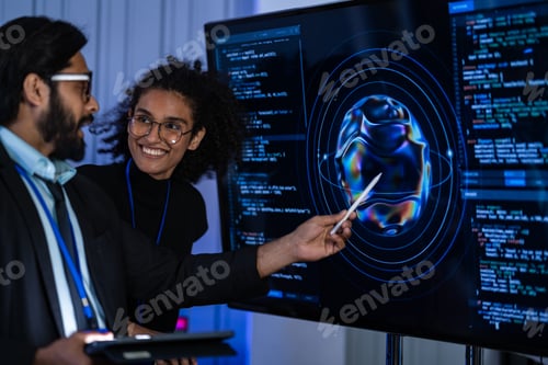 Preview: South Asian male IT professional and Black female researcher with a white bionic arm examine cyberse