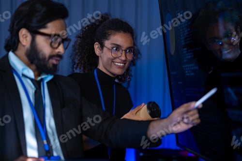 Preview: South Asian male cybersecurity engineer and Black female IT analyst with a bionic arm review network