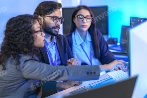 Preview: A male and a female IT professional planning the next development step as a team, side by side at a