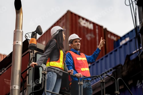 Preview: Two logistics workers man and woman discuss operations at a busy shipping container yard. successful