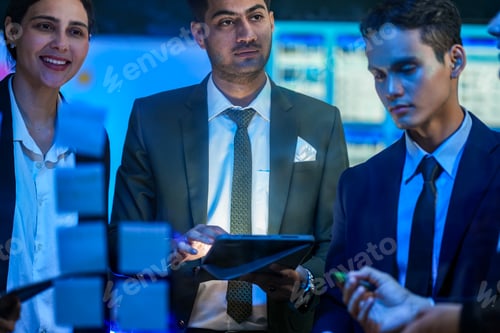 Preview: A focused business specialist placing a sticky note on a glass wall, leading a strategy session with