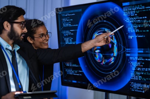 Preview: South Asian male IT professional with a tablet and Black female engineer with a bionic arm examine c