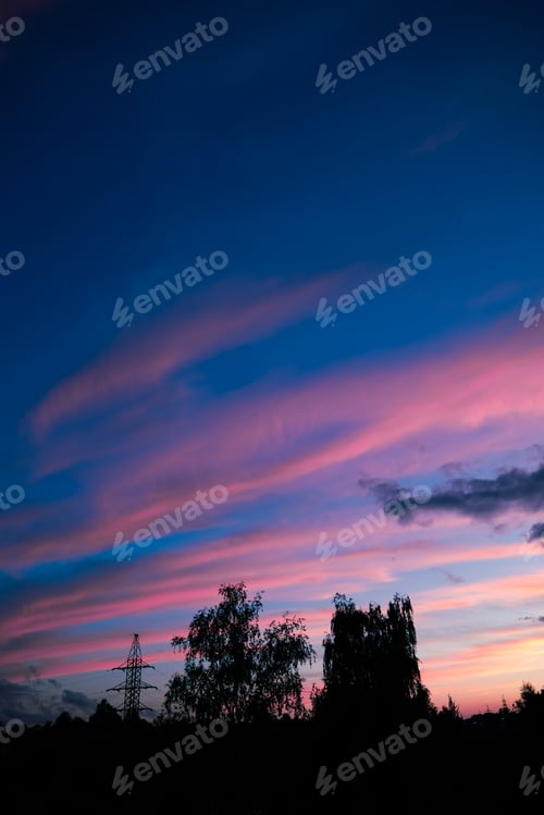 Preview: The sky displays a range of colors as the sun sets, with shades of pink and blue blending together.