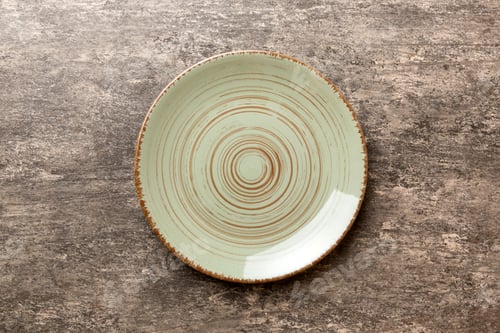 Preview: Top view of empty green plate on cement background. Empty space for your design