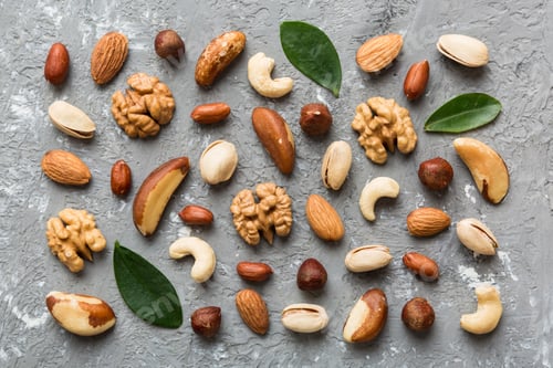Preview: Composition of nuts , flat lay - mix hazelnuts, cashews, almonds on table background. healthy eating