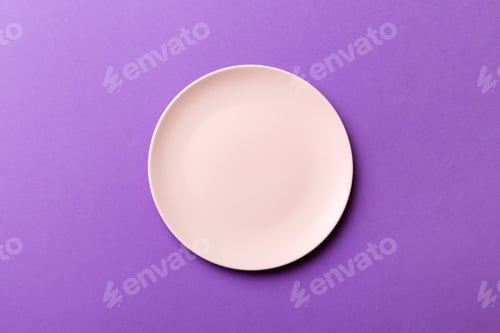 Preview: Top view of isolated of colored background empty round pink plate for food. Empty dish with space fo