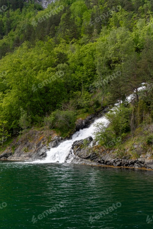 Preview: Spring waterfall cascading into Naeroyfjord in Norway