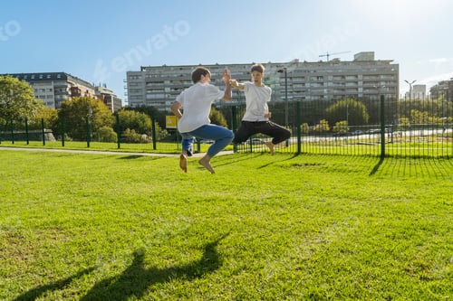 Preview: Two young men performing aerial Taekwondo kicks with copy space