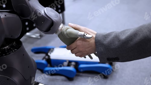 Preview: AI Robot shaking hands with man. Close up shaking hand with robotic arm