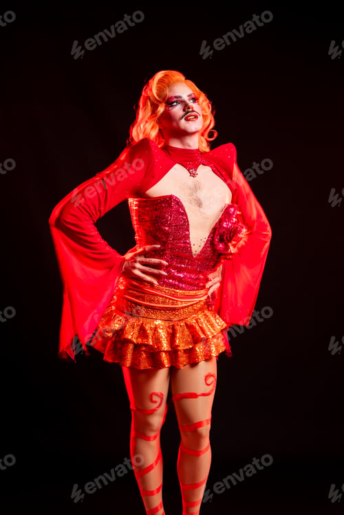 Preview: Drag Queen in Studio Posing With Bright Costume Against Black Backdrop