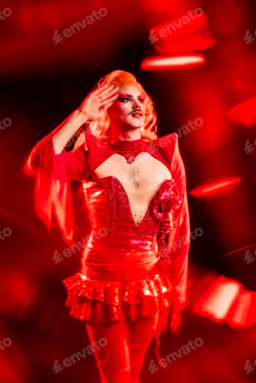 Preview: Fabulous Drag Queen Performs Under Red Lights in a Studio During a Lively Event