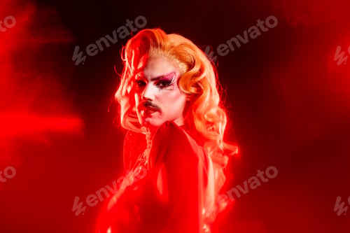 Preview: Portrait of a Drag Queen in Red Light With a Strong Aura in a Studio Setting